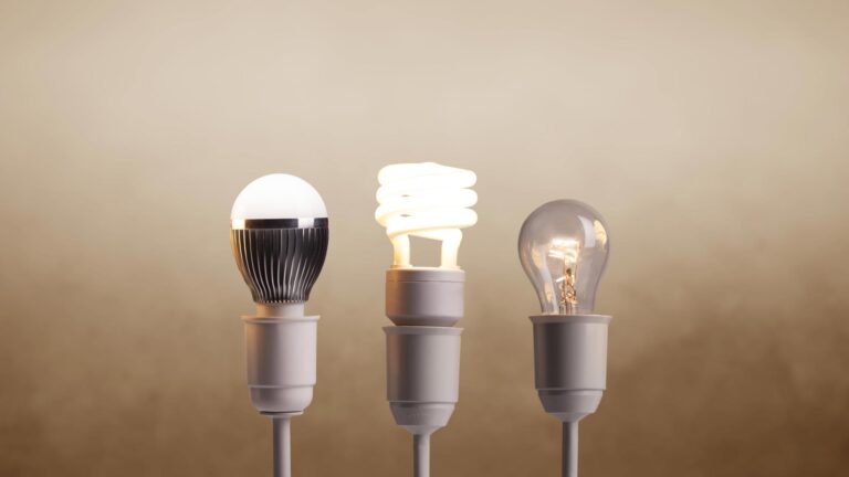 Image of three lamps side by side; two lamps are illuminated and casting light, while the other remains off and unlit