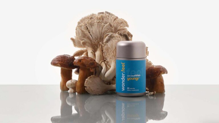 Wonderfeel Youngr bottle shown with fresh oyster mushrooms and porcini mushrooms, the source of ergothioneine.