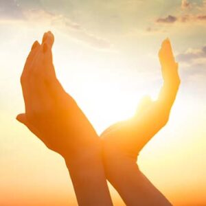 Upshot silhouette of hands capturing the sun's vitamin D3