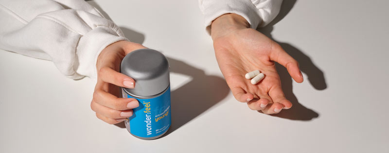 2 capsules in hand totaling 900 mg NMN for increased energy levels