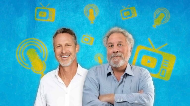 Dr. Mark Hyman and Professor Andrew Salzman stand smiling in front of a blue background